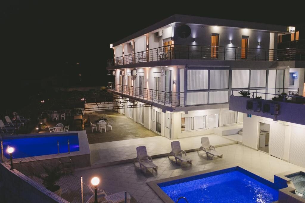 Vila Nikezić in Sutomore, Montenegro, illuminated at night with two outdoor swimming pools